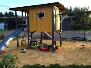 a playground with a play house and a slide at Ferienhaus Katja in Wienrode