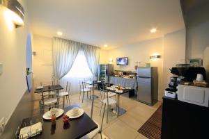 a kitchen with tables and chairs and a refrigerator at B&B Al Picchio in Monopoli