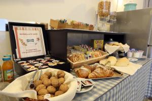 a table topped with baskets of pastries and bread at B&B Al Picchio in Monopoli