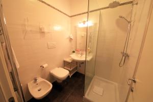 a bathroom with a shower and a toilet and a sink at B&B Al Picchio in Monopoli