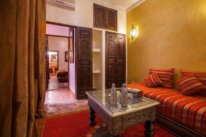 a living room with a couch and a table at Riad Alaka in Marrakesh