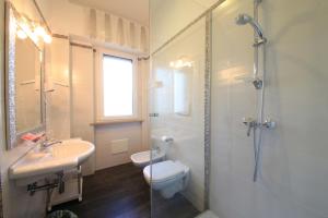 a bathroom with a toilet and a sink and a shower at B&B Al Picchio in Monopoli