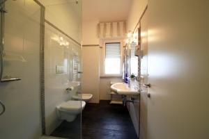 a bathroom with a toilet and a sink and a mirror at B&B Al Picchio in Monopoli
