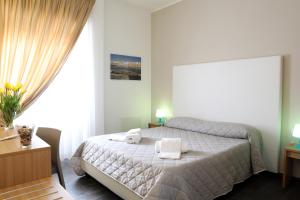 a bedroom with a bed with two towels on it at B&B Al Picchio in Monopoli