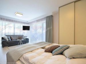 Łóżko lub łóżka w pokoju w obiekcie Polli Apartamenty
