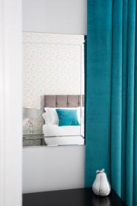 a bedroom with a bed with blue curtains at Crown Apartment in Inverness