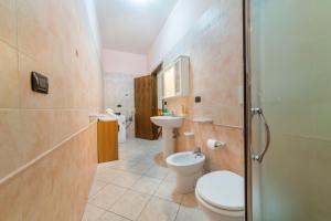 a bathroom with a toilet and a sink at Salento Sweet Home in Melissano +12 photos
