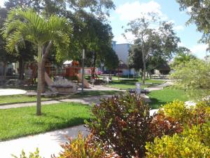 a park with a playground and a palm tree at Maaya in Puerto Morelos