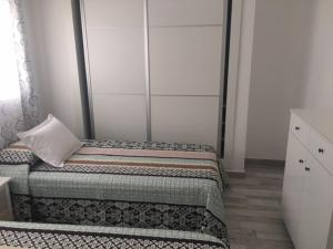 a bedroom with two beds with a pillow on it at Tajinastes in Arona