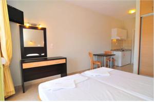 a bedroom with a bed and a television on a dresser at Thalassorama Studios in Skala Marion