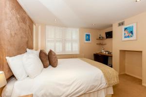 a bedroom with a large bed and a large window at Brightonwave in Brighton & Hove