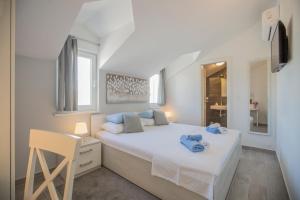 a bedroom with a bed with blue towels on it at Villa Giove in Grohote +51 photos