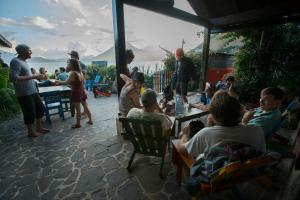 a group of people sitting around a table on a patio at La Iguana Perdida in Santa Cruz La Laguna