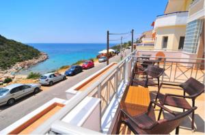 a balcony with chairs and a view of the ocean at Thalassorama Studios in Skala Marion