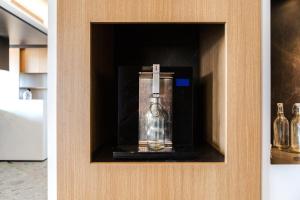 a glass appliance in a cabinet in a kitchen at MaisonMe Boutique Hotel in Bardolino