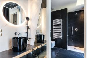 a bathroom with two large tubs and a mirror at MaisonMe Boutique Hotel in Bardolino