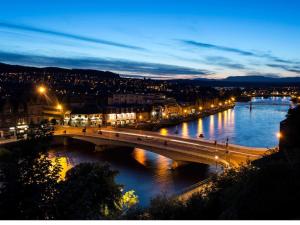 a bridge over a river in a city at night at Crown Apartment in Inverness