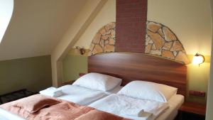 Letto o letti in una camera di Hotel Vinopa