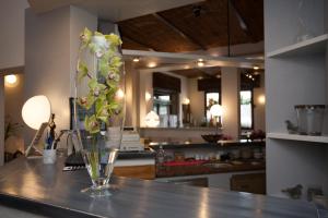 a vase with flowers on a counter in a kitchen at La Lanterna di Guiglia in Guiglia