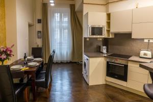 a kitchen and dining room with a table and a dining room at Dob Twenty Rooms in Budapest