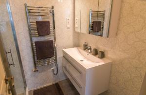 a bathroom with a sink and a mirror and a shower at Dob Twenty Rooms in Budapest