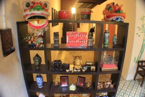 a shelf filled with vases and other items at Muntri House by Virtue Hospitality in George Town