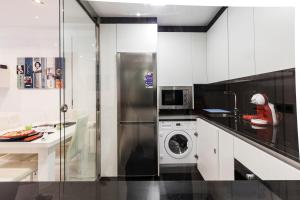 a kitchen with a washing machine and a microwave at Rent Apartment-Flat Salamanca in Salamanca