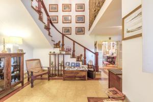 a living room with a staircase and a chair at Casa da Ria - Turismo Rural in Ílhavo