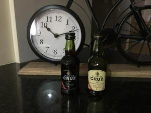 two bottles of beer on a table with a clock at Invicta House Arca D'Agua in Porto