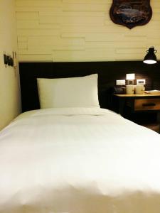 Postel nebo postele na pokoji v ubytování Re-Change Hotel Taipei