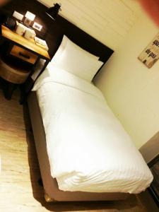 Postel nebo postele na pokoji v ubytování Re-Change Hotel Taipei
