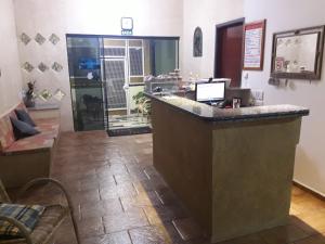 a lobby with a bar with a laptop on it at Hotel Nobre in Tupã