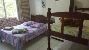 En eller flere senge i et værelse på Residencial Aracuã