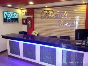a bar in a restaurant with a sign on the wall at Bicotels Hotel in Batangas City