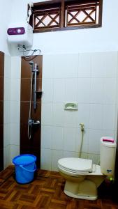 a bathroom with a toilet and a shower at City Stay Homestay Jogja in Yogyakarta