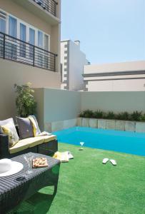 a small backyard with a patio furniture and grass at Cape Town Hollow Boutique Hotel in Cape Town