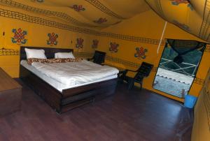 a bedroom with a bed in a tent at Jungle Stays in Chail