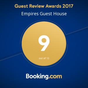 a yellow circle with the guest review awards entries guest house at Empire Guest House in Calangute