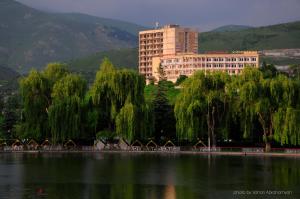 a large building next to a large body of water at Kirovakan Hotel in Vanadzor