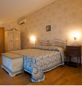 a bedroom with a bed and a wooden floor at Villa Ketty Resort in Vico Equense