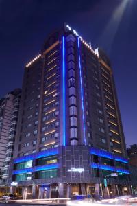 a large building with blue lights on it at The Tango Taichung in Taichung