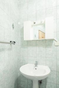 a white bathroom with a sink and a mirror at Mon Perin Castrum - Studio Apartment Castel in Bale