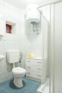 a white bathroom with a toilet and a sink at Mon Perin Castrum - Studio Apartment Castel in Bale