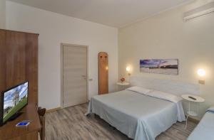 Postel nebo postele na pokoji v ubytování Hotel Cecile