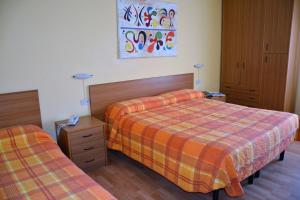 a hotel room with two beds in a room at Piccolo Hotel in Rosignano Solvay