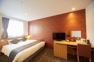 Postel nebo postele na pokoji v ubytování Sakura Garden Hotel