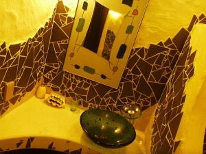 a bathroom counter with a mirror and a green sink at Taketomijima Akaneya in Taketomi