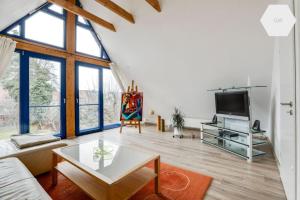 - un salon avec un canapé et une télévision dans l'établissement Apartment 81 qm, Messe/Exhibition Center, à Nuremberg