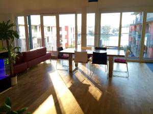 a living room with a couch and a table and chairs at Rhein Melodie riverview luxury in Konstanz