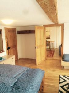 a bedroom with a bed and a open door at Im Dorf - Central in Herisau